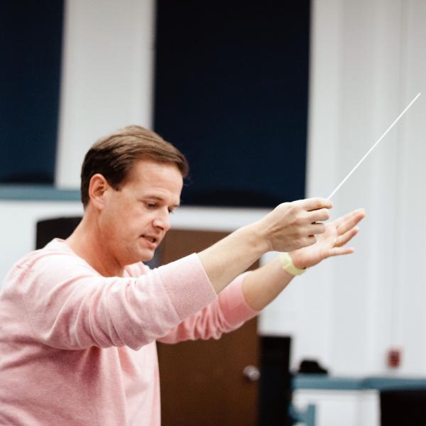 Benjamin Diden conducting an ensemble.